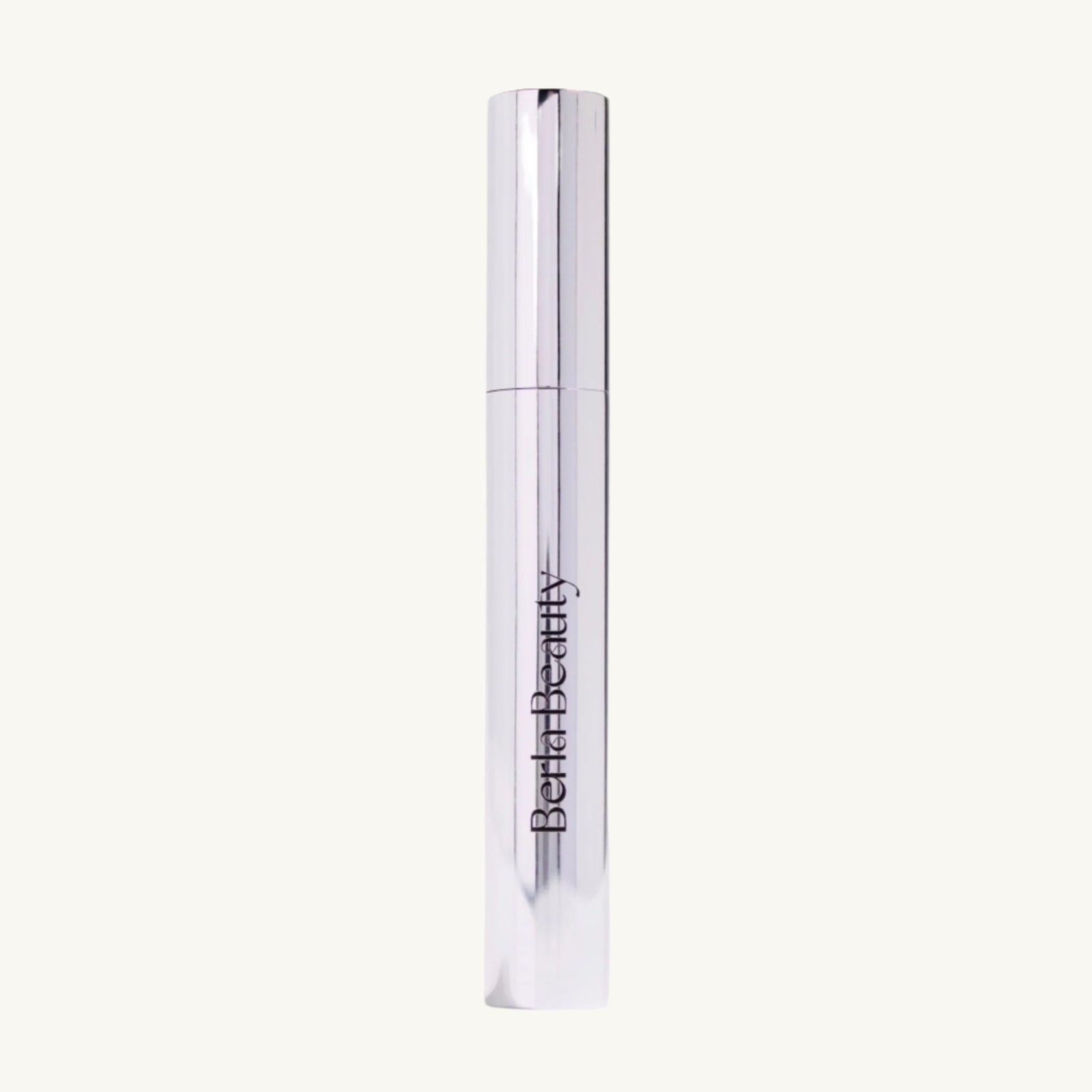 A sleek, metallic silver mascara tube with the brand name "Berla Beauty" printed vertically in black. The cap is off and resting beside the tube, revealing the wand with a white brush applicator designed for sculpted brows. The background is light beige. This product is the Vegan Clear Brow Gel - Long-Lasting Hold and Nourishing.