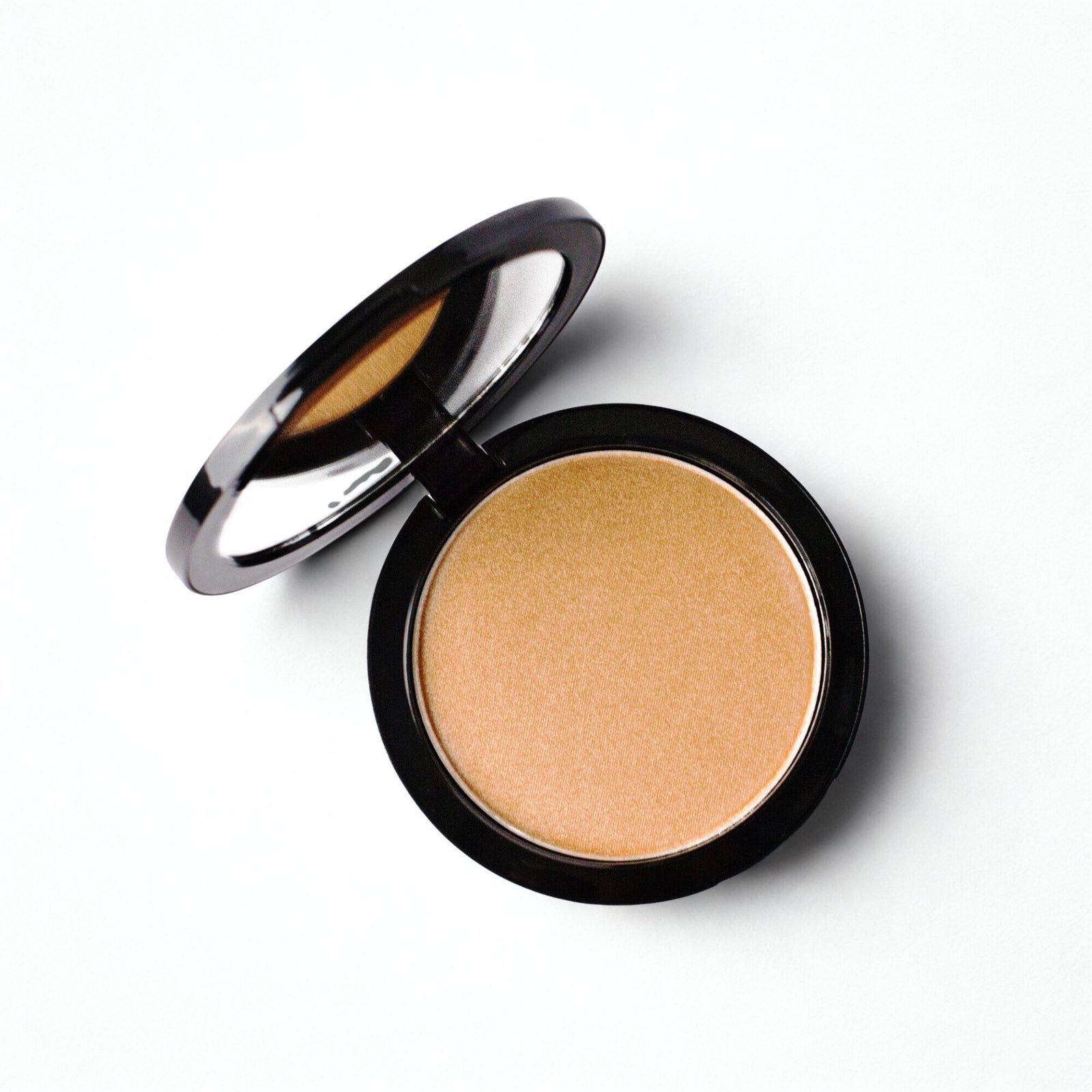 The Radiant Glow Luminizing Powder by Berla Beauty is displayed in a compact case with the lid open, showcasing its golden-toned luminizing powder. The round-shaped compact features a black outer rim and has a mirror inside the lid. This vegan formula offers a smooth, pressed texture for a radiant finish.